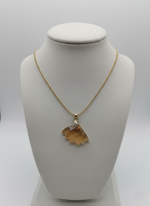 Necklace with a pendant on a mannequin bust against a white background