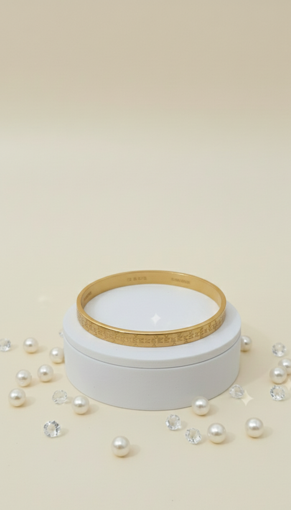 White jar with a gold lid on a beige background with scattered pearls