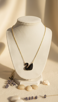 Necklace with a pendant on a white mannequin bust with a soft beige background