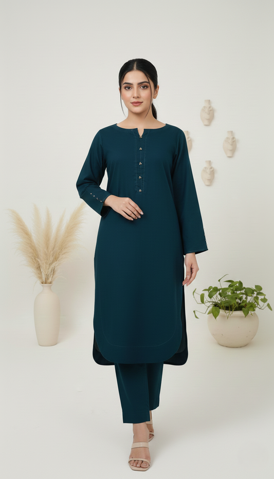Woman wearing a teal kurta with pants against a white background