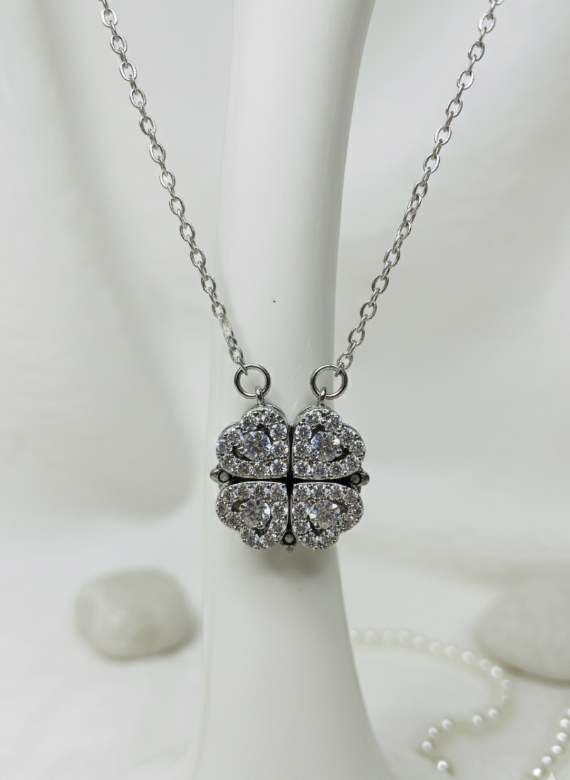 Silver necklace with a heart-shaped pendant on a white background